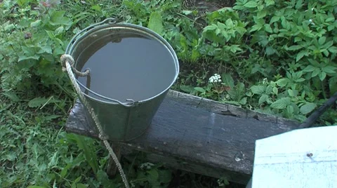 Bucket of water next to the well Stock Footage 7728045