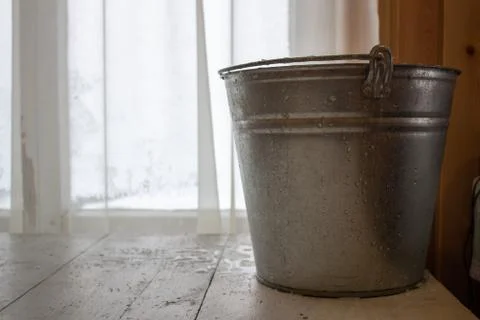 Bucket of water on the table in the cold. Close-up of an ice bucket on the ba Stock Photos