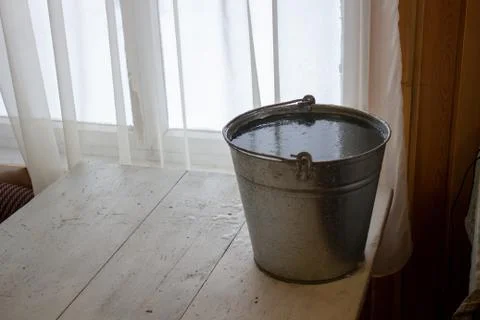 Bucket of water on the table in the cold. Close-up of an ice bucket on the ba Stock Photos