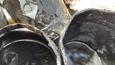 Buckets and various containers with hardened bitumen Stock Footage 239828098