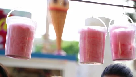 Buckets full of cotton candy haning from a fair stall Stock Footage 324756146
