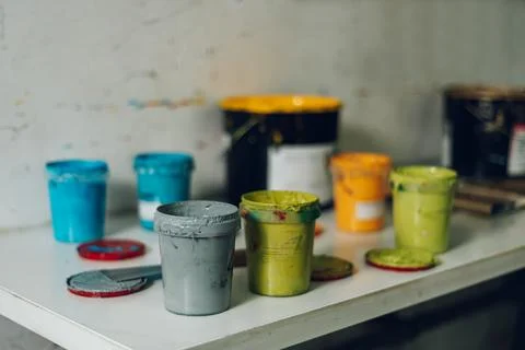 Buckets of paint set on a table Stock Photos