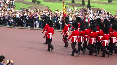 Buckingham Palace Changing of the guard marching passed crowds Stock Footage 42056579