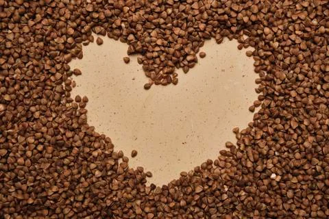 Buckwheat on a backdrop. rustic buckwheat background. buckwheat heart sign for Stock-Fotos