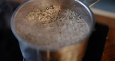 Buckwheat boiling in a cooking pan Stock Footage 146753963