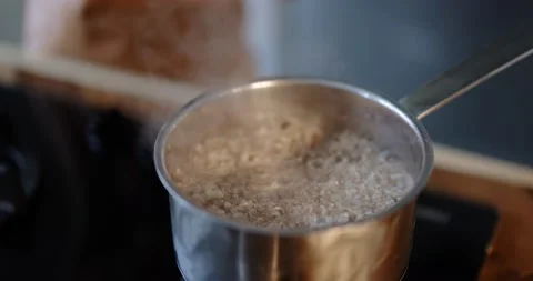 Buckwheat boiling in a cooking pan Stock Footage 146754079
