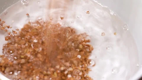 Buckwheat in boiling water, cooked in a pan. Stock Footage 248156108