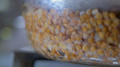 Buckwheat cooking process. Buckwheat is cooked in a transparent glass pan Stock Footage 309006893