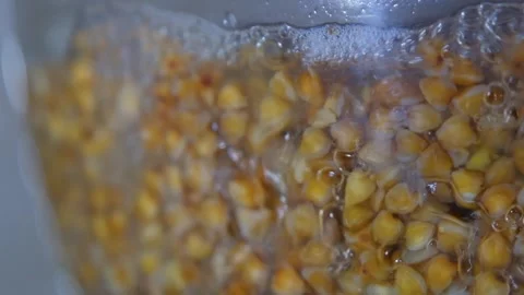Buckwheat cooking process. Buckwheat is cooked in a transparent glass pan Stock Footage 313754246
