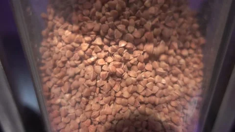 Buckwheat is filled into a glass flask. Stock Footage 144251689