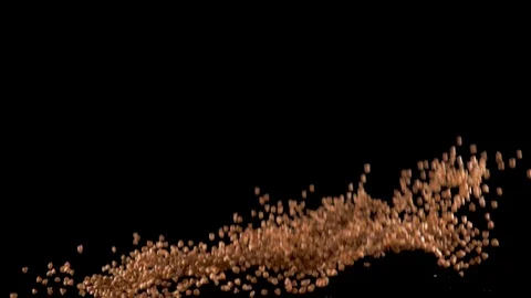 Buckwheat flies up and falls down on a black background. Slow motion. Food video Stock Footage 105679484
