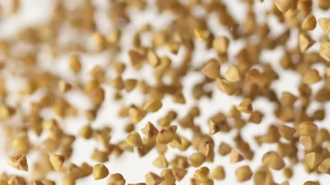 Buckwheat flying up on the white background in slow motion Video stock 148551834