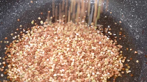 Buckwheat fried in a frying pan Stock Footage 254077585