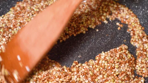 Buckwheat fried in a frying pan Stock Footage 254078007
