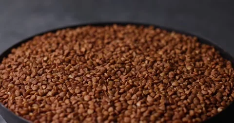 Buckwheat grains rotating loop macro tilt shift background Video stock 320980234