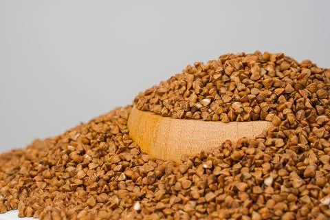 Buckwheat grains on white background. Stock Photos