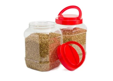 Buckwheat groats in two plastic containers with red covers Stock Photos