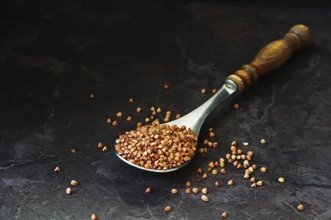 Buckwheat in an old spoon Stock Photos
