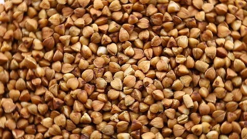 Buckwheat raw bulk rotate Stock-Footage 129764189