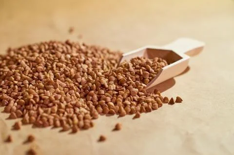 Buckwheat is scattered on the table close up Stock Photos
