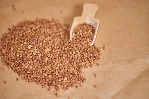 Buckwheat is scattered on the table close up Stock Photos
