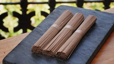 Buckwheat soba pasta on a black texture background.Raw thai noodles and Stock Footage 286359391
