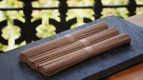 Buckwheat soba pasta on a black texture background.Raw thai noodles and Stock Footage 286359456
