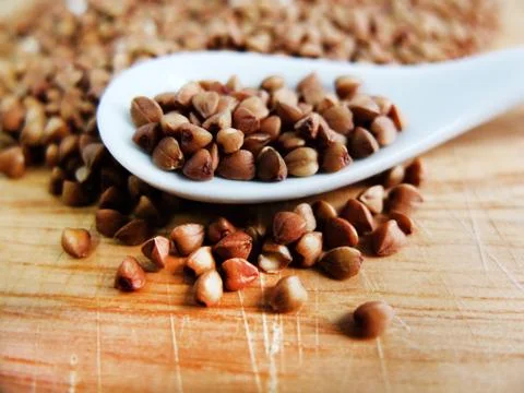 Buckwheat in a White Spoon Stock Photos
