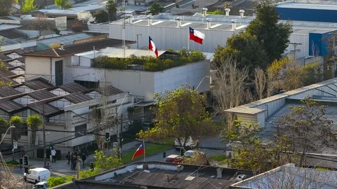 Bucolic evening shot of three flags of Chile trembling Stock Footage 97476388