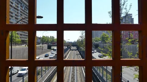 Bucolic view behind iron grid of subway train cruising along tracks Stock Footage 98116305