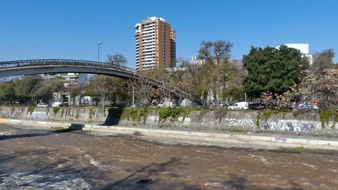 Bucolic view of bridge over the calm, shallow, brown waters Stock Footage 97097720