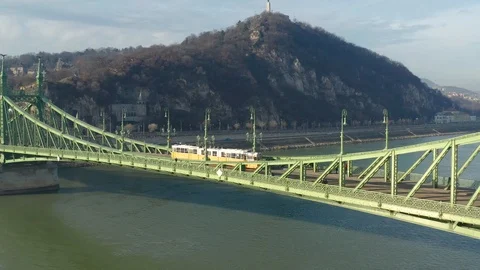 Budapest, Hungary - 4K drone flying by Liberty Bridge with yellow tram Stock Footage 121507399