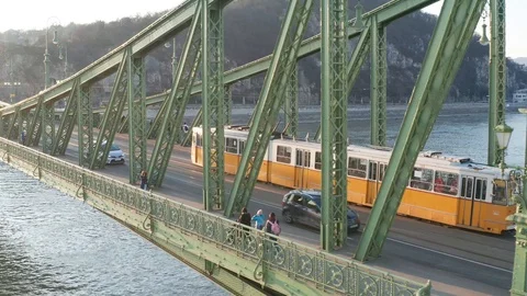 Budapest, Hungary - 4K drone flying by Liberty Bridge with yellow tram on it Video stock 122528963