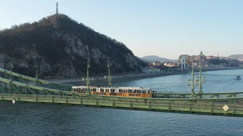 Budapest, Hungary - 4K drone flying by Liberty Bridge with yellow tram on it Stock Footage 122529004