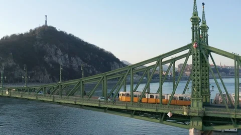 Budapest, Hungary - 4K drone flying by Liberty Bridge with yellow tram on it Stock Footage 122529009