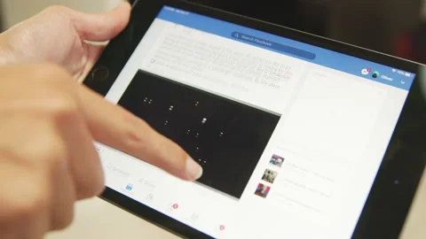 BUDAPEST, HUNGARY - CIRCA 2020: Browsing facebook on apple ipad Stock Footage 149883705
