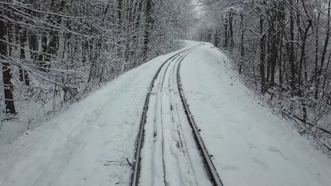 Budapest, Hungary - Going on train track in beautiful snowy woods at Huvosvolgy Stock Footage 84664829