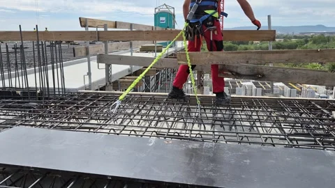 Budapest, Hungary - May 2026: Slow motion carpenter installing guardrail Stock Footage 337563241