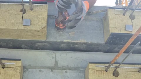 Budapest, Hungary - May 2026: Worker screwing lifting bolt into slab Stock Footage 337563233