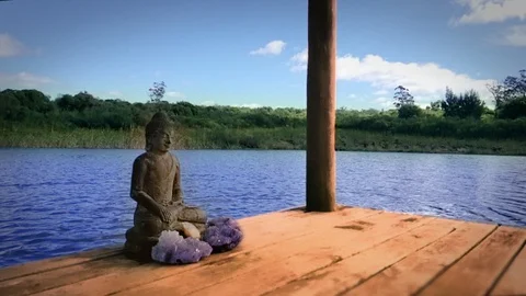 Buddah sitting on a pier Stock Footage 116124672