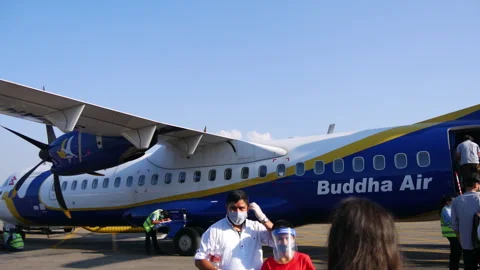 Buddha Airlines airplane loading passengers and baggage during covid. Stock Footage 281315530