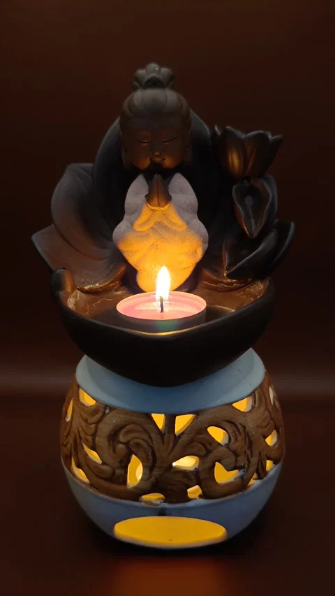 Buddha and a burning candle in a lamp, atmosphere for meditation Stock Footage 330310076