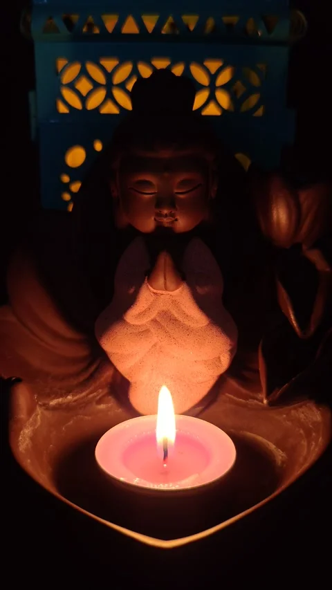 Buddha candlestick with candle in the dark Stock Footage 330310654