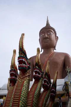 Buddha image, large, brown, has  serpent 5 heads, with sky in the background Stock Photos
