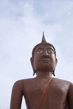 Buddha image, large, brown, with sky in the background Stock Photos