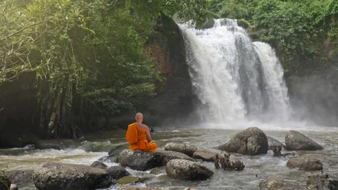Buddha monk practice meditation at  waterfall in rainforest Vídeos de archivo 205557571