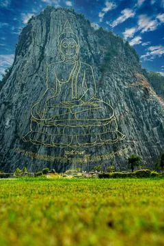 Buddha Mountain a biggest image of Buddha engraved on the rock. Thai text bel Stock Photos