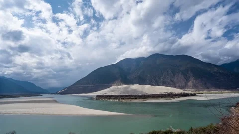 Buddha Palm Sand Dune across a green river in Tibet Stock Footage 345881042