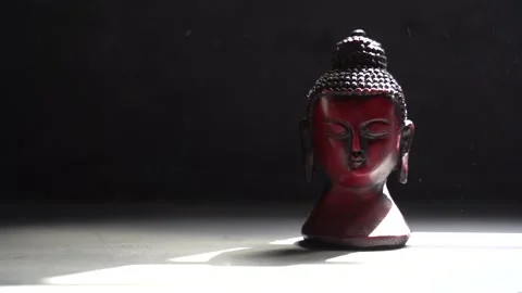 Buddha red Idol face with black background Stock Footage 136593064