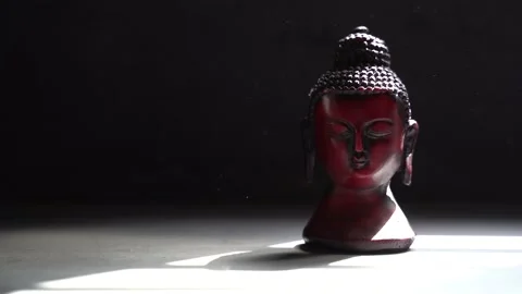 Buddha red Idol face with black background Stock Footage 136593078